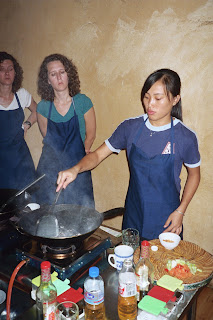 Showing us how to cook with a Wok