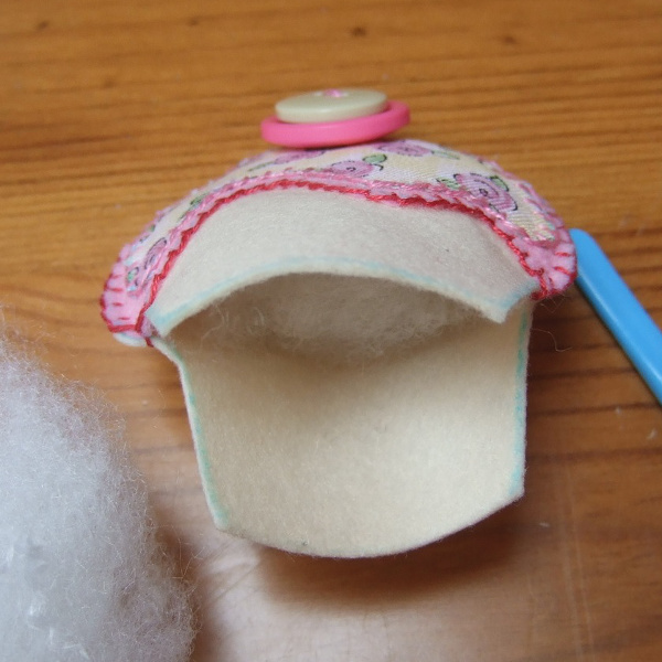 Adding fiber fill stuffing inside a homemade felt plushie