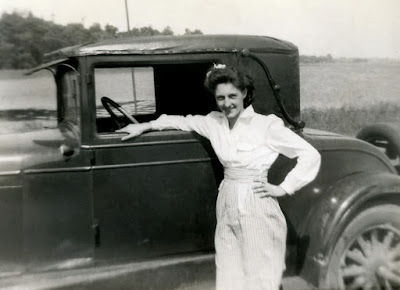 Pretty woman with an old Model A or Model T Ford.