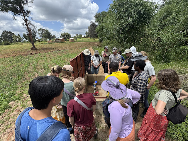 A group of students around a borehole.