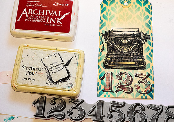 Layers of ink - Typewriter tag tutorial by Anna-Karin Evaldsson. Stamp numbers with black and red ink.