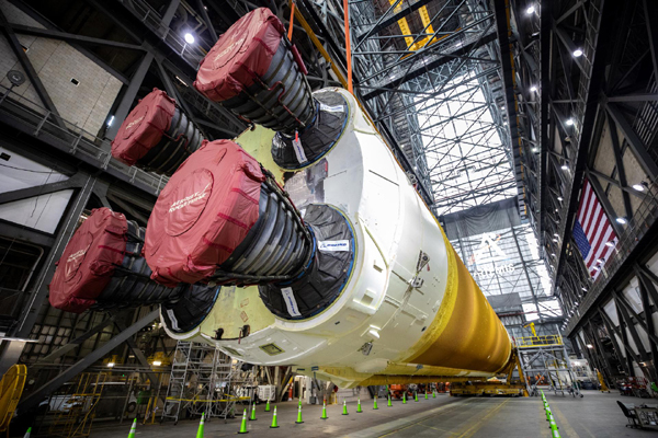 Inside the VAB, the SLS core stage booster for Artemis 1 is lifted into the air by two large cranes at NASA's Kennedy Space Center in Florida...on June 10, 2021.