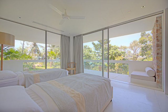 Picture of modern bedroom with two beds and glass walls