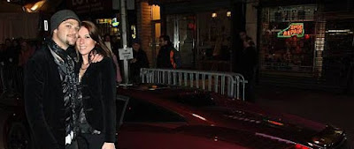 Missy Rothstein posing for picture with her ex-husband Bam in front of car