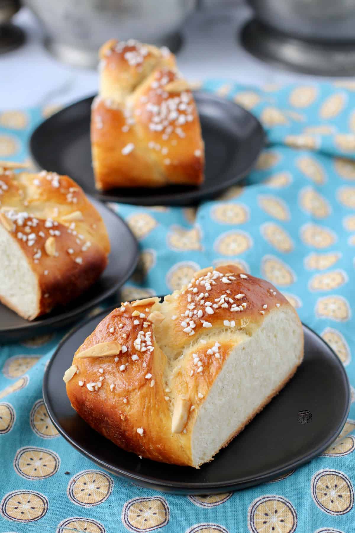 Finnish Pulla Bread slices on black plates.