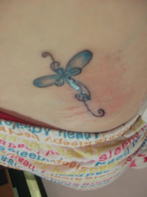 Cute dragonfly tattoo on female's chest.