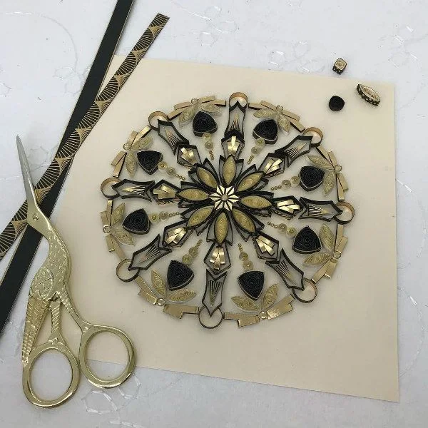 quilled mandala with metallic accents and example paper strips and detail stork scissors