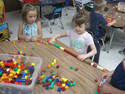 girl playing woth unifix cubes