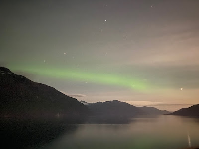 Northern Lights over mountains and ocean in Whittier Alaska