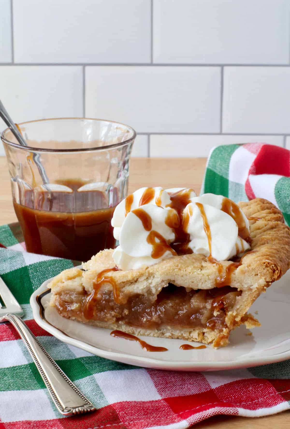 Apple Cider Pie with whipped cream and caramel sauce.