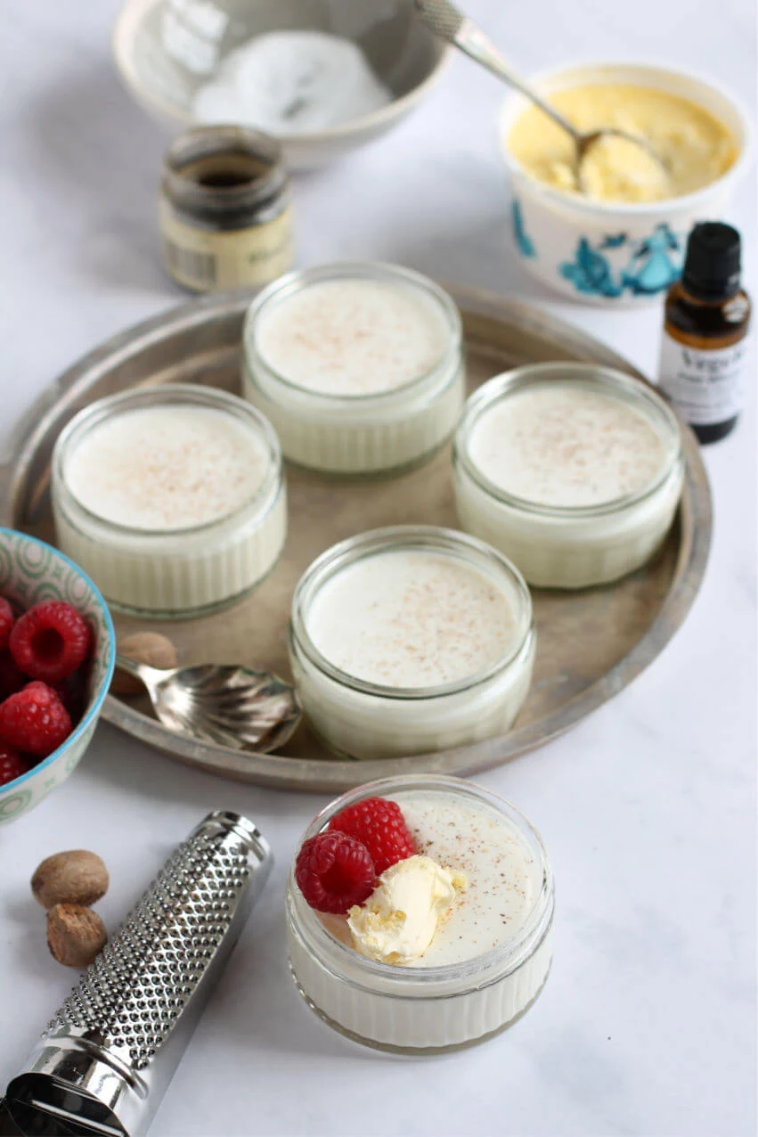 Individual pots of creamy junket with nutmeg