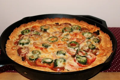 Cast iron skillet with finished tomato, bacon, and jalapeno skillet pie.