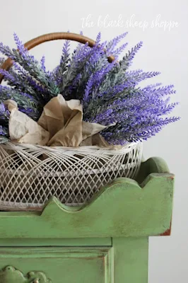 Basket of lavender on green dry sink.