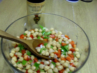 Mezclando los garbanzos con las verduras y la vinagreta