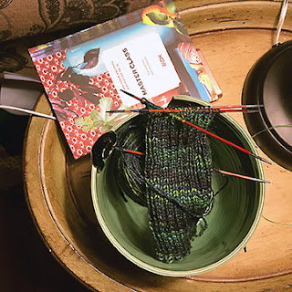 Bearfoot Sock in a green yarn bowl