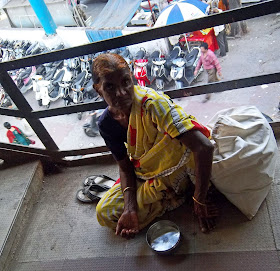 elderly woman beggar on railway bridge