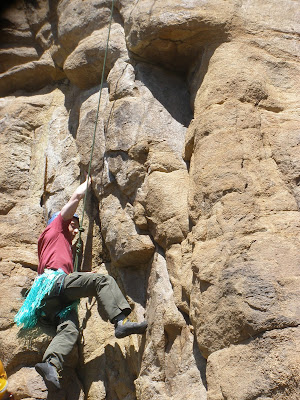 Benjamin Rubenstein rock-climbing in hula skirt in Estes Park