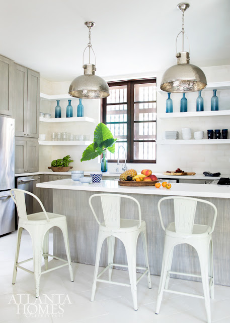 Beautiful white kitchen with open shelving and blue accents