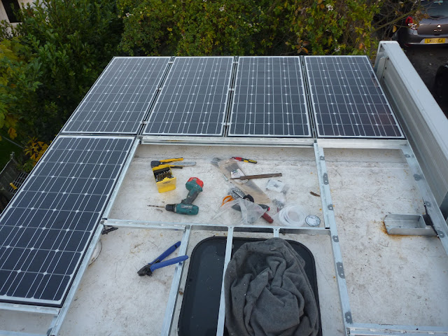 5 of the 8 solar panels mounted on the roof rack of Jim the overland motorhome truck