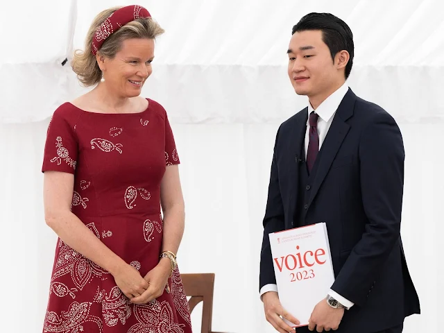 Queen Mathilde wore a bespoke wine red Josie dress by Natan. Pearl earrings, Natan hat. South Korean baritone Taehan Kim