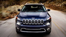 Head on shot of the 2014 Jeep Cherokee driving on a two-lane road