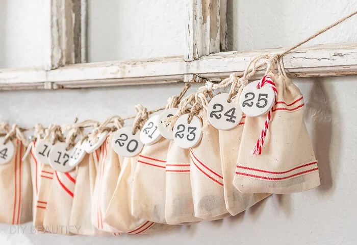 faux grain sack bags with numbered clay tags for a Christmas advent countdown