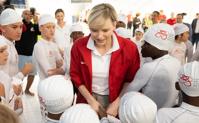 Sainte Devote Rugby Tournament. Princess Charlene of Monaco wore a red track jacket by Nike, and camel pants