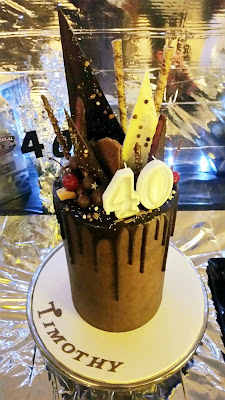 40th Birthday Male Chocolate on Chocolate Drip Cake. Topped with bark, lollies and candy.