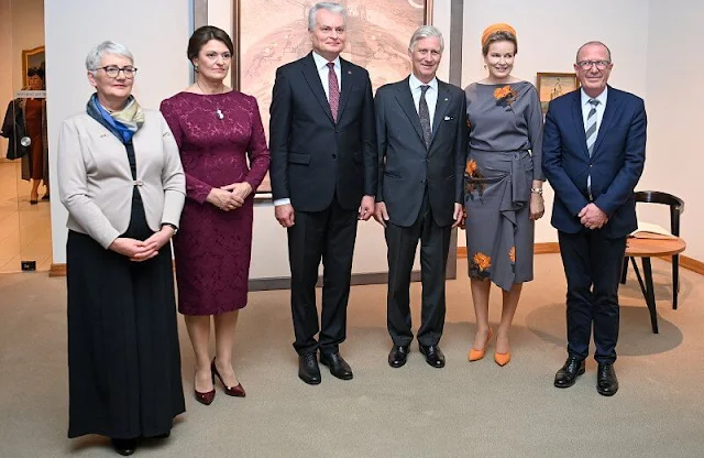 Fabienne Delvigne hat and Dries Van Noten grey yellow flower dress. Queen Mathilde and First Lady Diana Nausėdienė