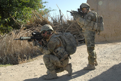 Royal Marines from 40 Commando on patrol in the Sangin area of Afghanistan with an L129A1 Sharpshooter rifle and an L85A2 assault rifle on the 6th of June 2010