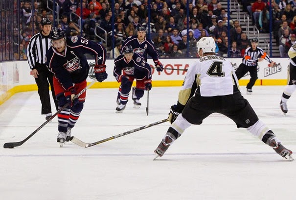 Dec 29, 2013; Columbus, OH, USA; Columbus Blue Jackets center Mark Letestu (55) passes the puck as Pittsburgh Penguins defenseman Rob Scuderi (4) during the second period at Nationwide Arena. Mandatory Credit: Russell LaBounty-USA TODAY Sports