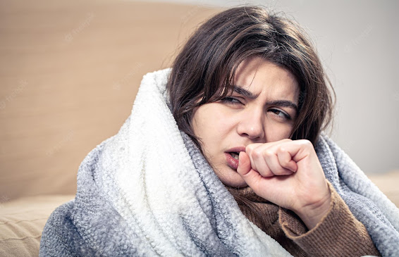 A woman suffering from cough and cold