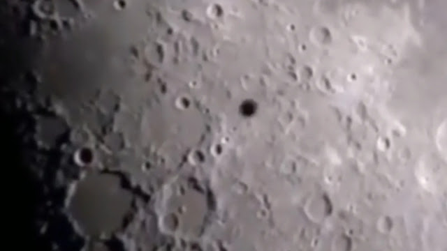 A UFO sighting over the Moon's surface.