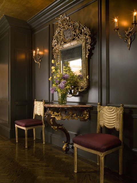 chocolate black walls ornate gold mirror hallway