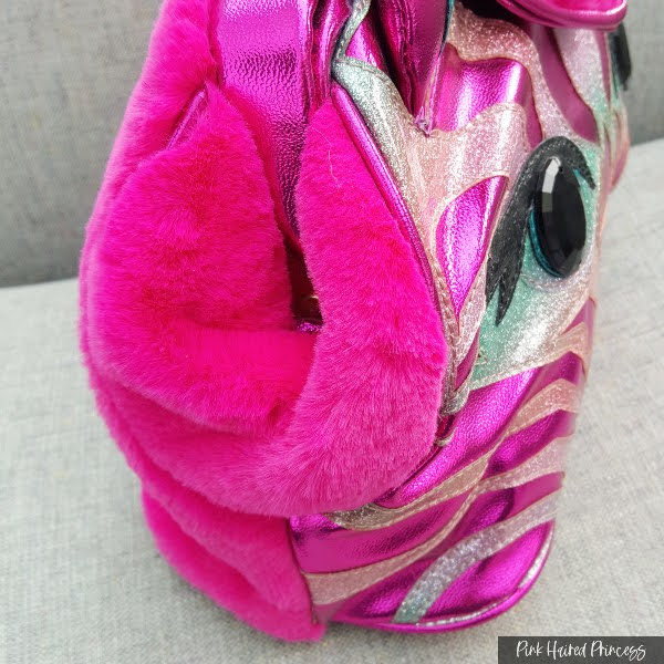 pink faux fur gussets on side of zebra handbag