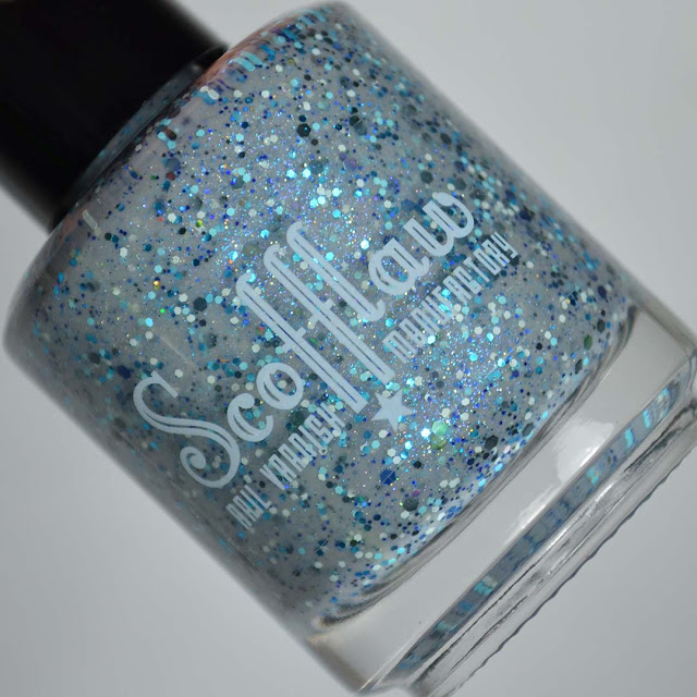 grey nail polish with glitter in a bottle