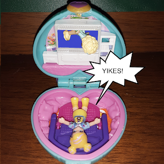 Polly Pocket doll lies on fold-out sofa, shouting "YIKES!" as older style Polly Pocket doll falls out of television screen.