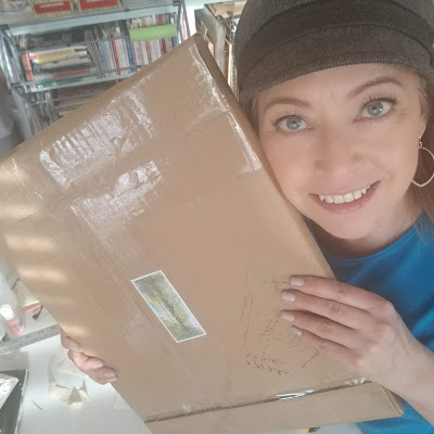 Newest art sale ready to ship!  Brown cardboard package in my hands.