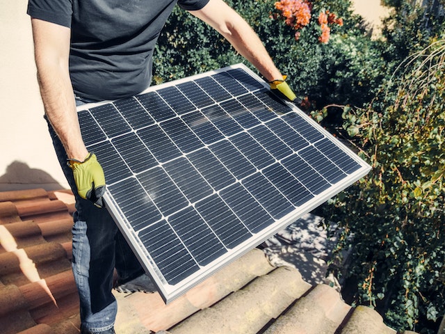 A man holding a solar panel