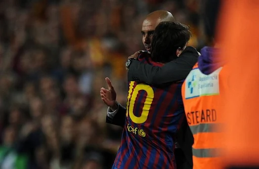 Lionel Messi hugs his Barcelona coach Pep Guardiola after scoring his hat-trick against Espanyol