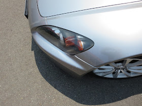 Close up of alignment problems on bumper and fender after accident.