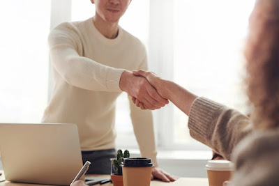 photo of developer shaking hands with a customer