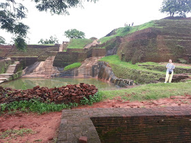 View on magnificent Granite Pool wholly carved, rock, foot of pyramid, summit, ancient, Sigiriya, history mysteries