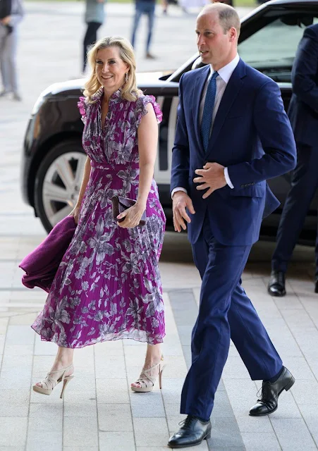 The Duchess of-Edinburgh wore a new Roisin purple printed voile midi silk dress by Erdem. Diamond earrings