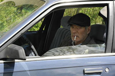 Stephen Lang watches Joan Allen's house from his car in a movie still for the 2014 film adaptation of "A Good Marriage" 