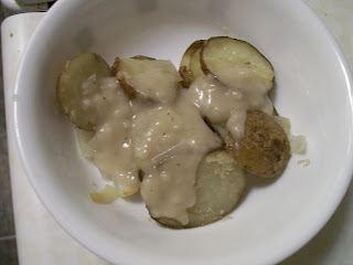 Roast potatoes and onions with brown sauce.