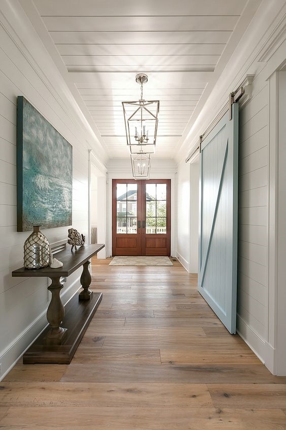 light blue barn door and console table