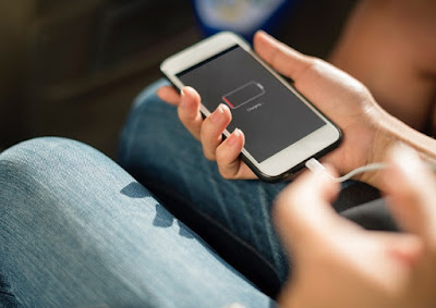 Person charging a phone with dead battery