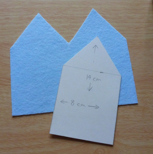 Blue felt house shaped outline cut from cardboard template