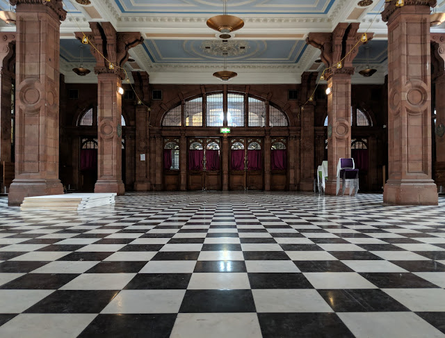 Black and white tiled floor in large hall